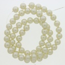 Perla cristal redonda Ø 7mm 2 agujeros. Color crema.