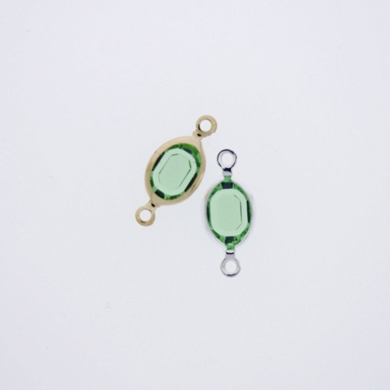 Entrepieza con strass ovalado 6x8mm color verde. Longitud 16mm